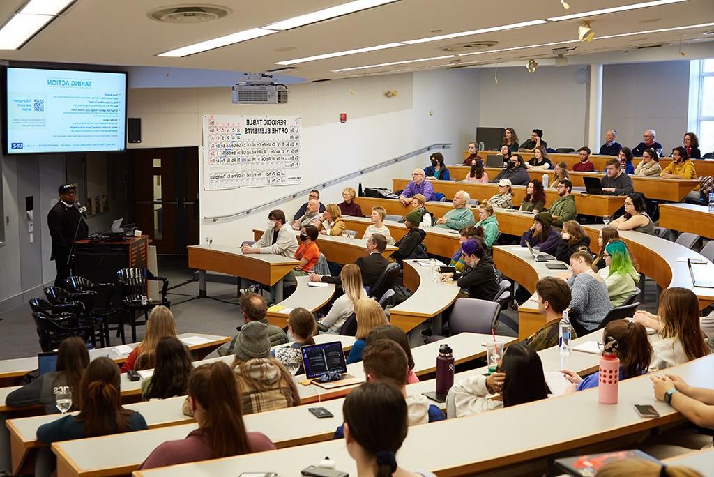 Students in a lecture hall listening to a speaker at a Climate Teach-In event